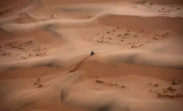 Milan Engel rides on the sand dunes during the seventh stage of the Dakar Rally with start and finish in Al Duwadimi, Saudi Arabia, Sunday, Jan. 12, 2025. (AP Photo/Christophe Ena)