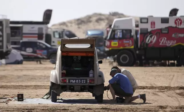 Mechanics prepare the Citroën 2CV of Netherlands' Floris De Raadt and David Kann two days before the start of the Dakar Rally in Bisha, Saudi Arabia, Wednesday, Jan. 1, 2025. (AP Photo/Christophe Ena)