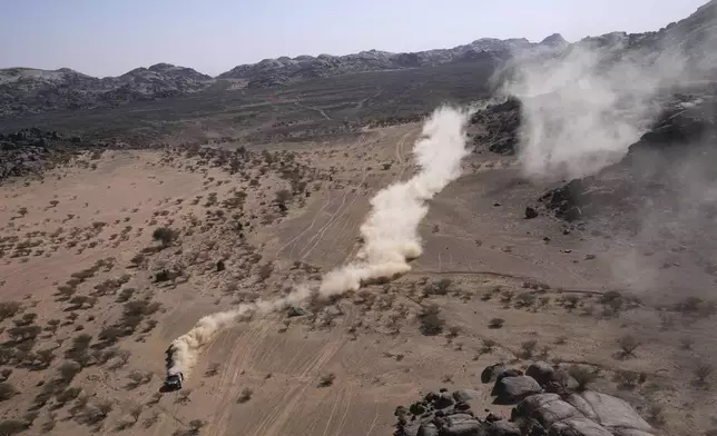 Driver Sebastien Loeb and co-driver Fabian Lurquin compete after a crash during the third stage of the Dakar Rally between Bisha and Al-Henakiyah, Saudi Arabia, Tuesday, Jan. 7, 2025. (AP Photo/Christophe Ena)