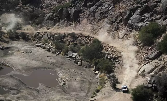 Driver Guillaume De Mevius and co-driver Mathieu Baumel compete during stage one of the Dakar Rally with start and finish in Bisha, Saudi Arabia, Saturday, Jan. 4, 2025. (AP Photo/Christophe Ena)