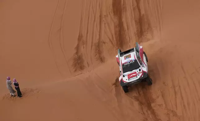 Driver Juan Cruz Yacopini and co-driver Daniel Oliveras compete during the sixth stage of the Dakar Rally between Hail and Al Duwadimi, Saudi Arabia, Saturday, Jan. 11, 2025. (AP Photo/Christophe Ena)