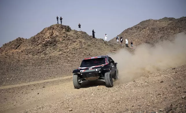 Driver Sebastien Loeb and co-driver Fabian Lurquin compete during the prologue of the Dakar Rally in Bisha, Saudi Arabia, Friday, Jan. 3, 2025. (AP Photo/Christophe Ena)