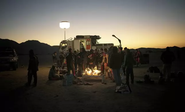 Riders and drivers have a breakfast prior to the start of the stage two, day two, of the Dakar Rally, in Bisha, Saudi Arabia, Monday, Jan. 6, 2025. (AP Photo/Christophe Ena)
