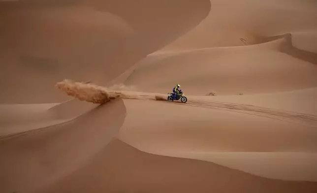 Milan Engel rides on the sand dunes during the seventh stage of the Dakar Rally with start and finish in Al Duwadimi, Saudi Arabia, Sunday, Jan. 12, 2025. (AP Photo/Christophe Ena)