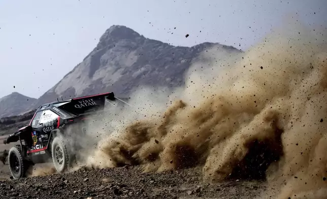 Driver Nasser Al-Attiyah and co-driver Edouard Boulanger competes during the prologue of the Dakar Rally in Bisha, Saudi Arabia, Friday, Jan. 3, 2025. (AP Photo/Christophe Ena)