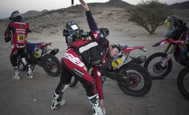 Rider Ricky Brabec of the U.S stretches prior to taking part to the stage two, day two, of the Dakar Rally with start in Bisha and finish in Bisha, Saudi Arabia, Monday, Jan. 6, 2025. (AP Photo/Christophe Ena)