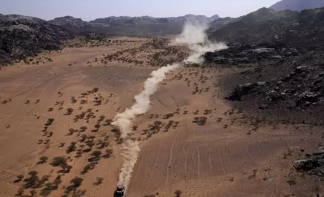 Daccia driver Nasser Al-Attiyah and co-driver Edouard Boulanger compete during the third stage of the Dakar Rally between Bisha and Al-Henakiyah, Saudi Arabia, Tuesday, Jan. 7, 2025. (AP Photo/Christophe Ena)