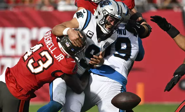 Tampa Bay Buccaneers linebacker Chris Braswell forces a fumble by Carolina Panthers quarterback Bryce Young during the second half of an NFL football game Sunday, Dec. 29, 2024, in Tampa, Fla. (AP Photo/Jason Behnken)