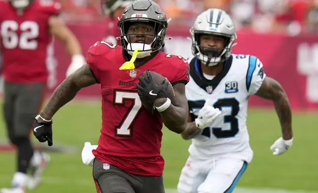 Tampa Bay Buccaneers running back Bucky Irving runs against the Carolina Panthers during the first half of an NFL football game Sunday, Dec. 29, 2024, in Tampa, Fla. (AP Photo/Chris O'Meara)