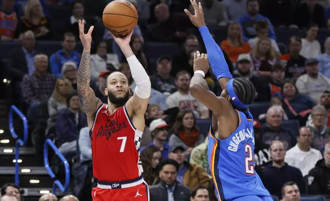 Los Angeles Clippers guard Amir Coffey (7) shoots over Oklahoma City Thunder guard Shai Gilgeous-Alexander (2) during the second half of an NBA basketball game Thursday, Jan. 2, 2025, in Oklahoma City. (AP Photo/Nate Billings)