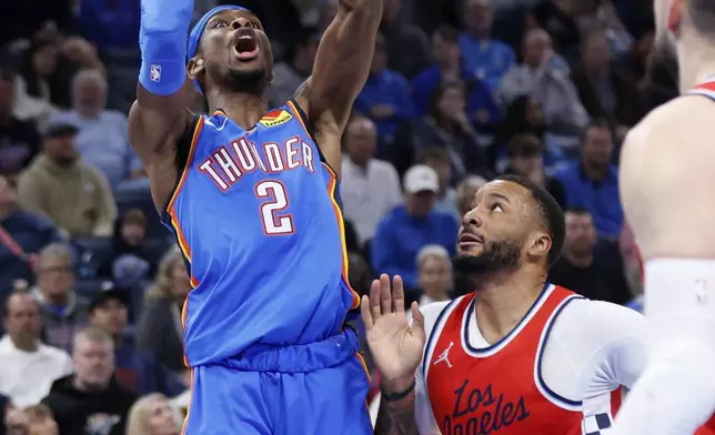 Oklahoma City Thunder guard Shai Gilgeous-Alexander (2) shoots over Los Angeles Clippers guard Norman Powell (24) during the first half of an NBA basketball game Thursday, Jan. 2, 2025, in Oklahoma City. (AP Photo/Nate Billings)