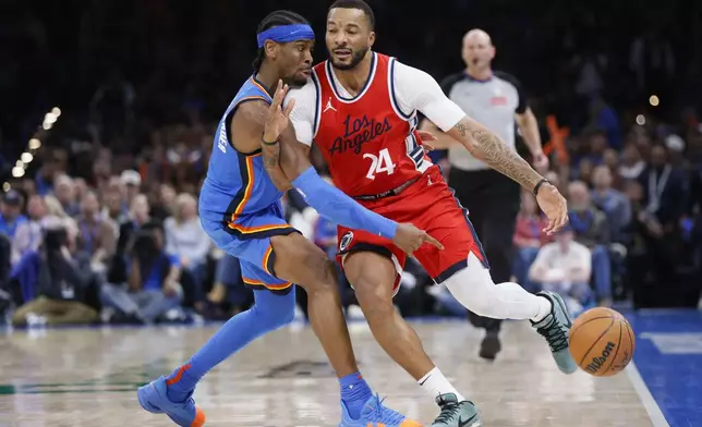 Oklahoma City Thunder guard Shai Gilgeous-Alexander, left, knocks the ball away from Los Angeles Clippers guard Norman Powell (24) during the second half of an NBA basketball game Thursday, Jan. 2, 2025, in Oklahoma City. (AP Photo/Nate Billings)