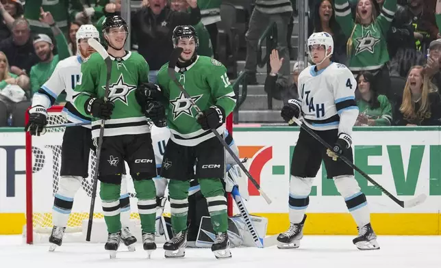 Dallas Stars center Oskar Back front left, and right wing Arttu Hyry center, react after Back scored a goal against the Utah Hockey Club during the second period of an NHL hockey game, Saturday, Jan. 4, 2025, in Dallas. Hyry recorded his first career point while assisting Back on the goal. (AP Photo/Julio Cortez)