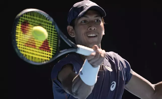 Kasidit Samrej of Thailand plays a forehand return to Daniil Medvedev of Russia during their first round match at the Australian Open tennis championship in Melbourne, Australia, Tuesday, Jan. 14, 2025. (AP Photo/Ng Han Guan)