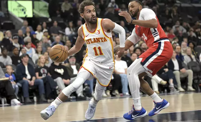 Atlanta Hawks guard Trae Young, left, is defended by Los Angeles Clippers guard Norman Powell during the first half of an NBA basketball game Saturday, Jan. 4, 2025, in Los Angeles. (AP Photo/Jayne-Kamin-Oncea)