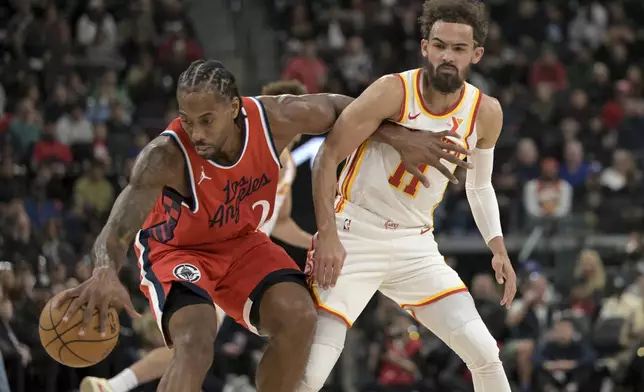 Los Angeles Clippers forward Kawhi Leonard, left, steals the ball from Atlanta Hawks guard Trae Young during the first half of an NBA basketball game Saturday, Jan. 4, 2025, in Los Angeles. (AP Photo/Jayne-Kamin-Oncea)