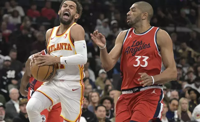 Atlanta Hawks guard Trae Young drives past Los Angeles Clippers forward Nicolas Batum (33) during the first half of an NBA basketball game Saturday, Jan. 4, 2025, in Los Angeles. (AP Photo/Jayne-Kamin-Oncea)