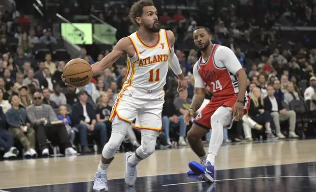 Atlanta Hawks guard Trae Young, left, is defended by Los Angeles Clippers guard Norman Powell during the first half of an NBA basketball game Saturday, Jan. 4, 2025, in Los Angeles. (AP Photo/Jayne-Kamin-Oncea)