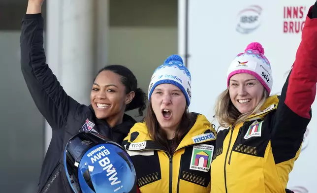 Second placed Kaysha Love, of the United States, winner Lisa Buckwitz, of Germany, and third placed Laura Nolte, of Germany, from left, pose together after competing in the women's monobob at the Bobsleigh World Cup in Innsbruck, Austria, Saturday, Jan. 18, 2025. (AP Photo/Matthias Schrader)