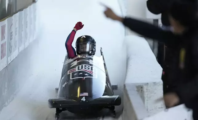 Kaysha Love, of the United States, celebrates as she finishes her second run in the women's monobob at the Bobsleigh World Cup in Innsbruck, Austria, Saturday, Jan. 18, 2025. (AP Photo/Matthias Schrader)