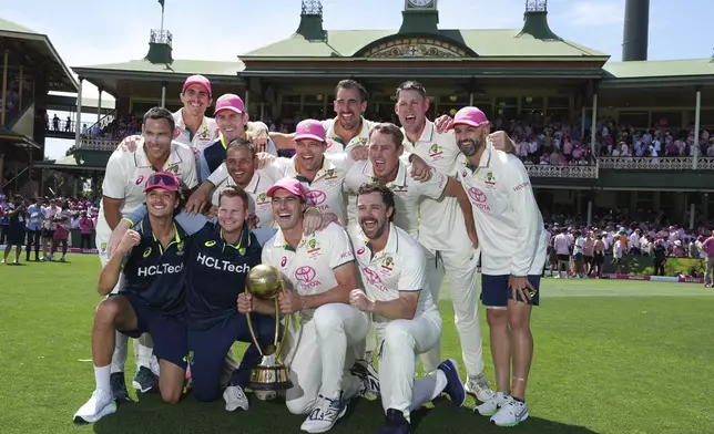 The Australian team pose with the Border Gavaskar Trophy after defeating India in the fifth cricket test at the Sydney Cricket Ground, in Sydney, Australia, Sunday, Jan. 5, 2025. (AP Photo/Mark Baker)