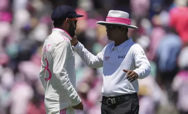 India's Virat Kohli, left, talks with umpire Sharfuddoula Saikat during play on the third day of the fifth cricket test between India and Australia at the Sydney Cricket Ground, in Sydney, Australia, Sunday, Jan. 5, 2025. (AP Photo/Mark Baker)