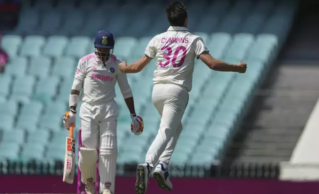 Australia's captain Pat Cummins, right, celebrates after dismissing India's Ravindra Jadeja, left, during play on the third day of the fifth cricket test between India and Australia at the Sydney Cricket Ground, in Sydney, Australia, Sunday, Jan. 5, 2025. (AP Photo/Mark Baker)