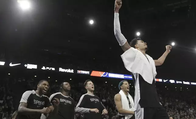 San Antonio Spurs center Victor Wembanyama, right, and teammates celebrate during the second half of a Paris Games 2025 NBA basketball game against the Indiana Pacers in Paris, Thursday, Jan. 23, 2025. (AP Photo/Thibault Camus)