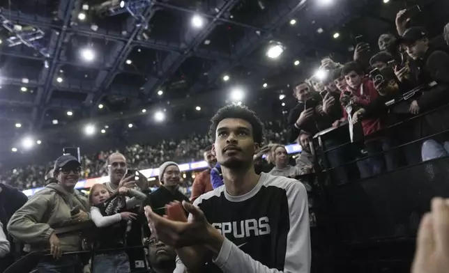 San Antonio Spurs center Victor Wembanyama (1) claps following a Paris Games 2025 NBA basketball game against the Indiana Pacers in Paris, Saturday, Jan. 25, 2025. (AP Photo/Thibault Camus)