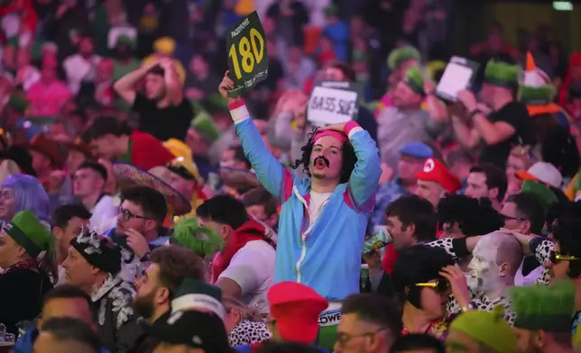 A fan dressed in costume is seen during the semifinal match between Michael van Gerwen of the Netherlands and Chris Dobey of England, at the World Darts Championship in London, Thursday, Jan. 2, 2025. (AP Photo/Kirsty Wigglesworth)