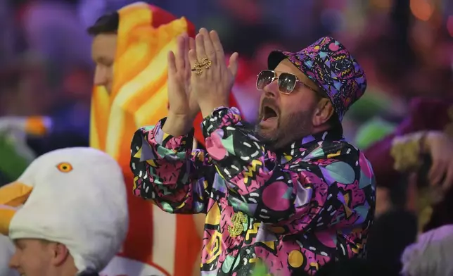 A fan dressed in costume is seen during the semifinal match between Michael van Gerwen of the Netherlands and Chris Dobey of England, at the World Darts Championship in London, Thursday, Jan. 2, 2025. (AP Photo/Kirsty Wigglesworth)