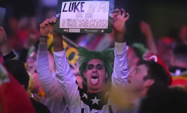 A fan dressed in costume is seen during the semifinal match between Luke Littler of England and Stephen Bunting of England, at the World Darts Championship in London, Thursday, Jan. 2, 2025. (AP Photo/Kirsty Wigglesworth)