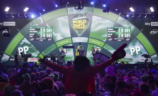 Fans react during the quarter final match between Callan Rydz of England and Michael Van Gerwen of the Netherlands at the World Darts Championship in London, Wednesday, Jan. 1, 2025.(AP Photo/Alberto Pezzali)