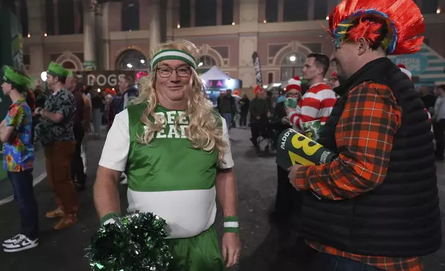 Fans arrive for the final of the World Darts Championship at Alexandra Palace in London, Friday, Jan. 3, 2025. (AP Photo/Kirsty Wigglesworth)