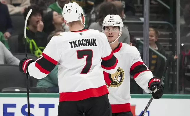 Ottawa Senators left wing Brady Tkachuk (7) celebrates his first period goal with Shane Pinto during an NHL hokey game against the Dallas Stars, Thursday, Jan. 2, 2025, in Dallas. (AP Photo/Julio Cortez)