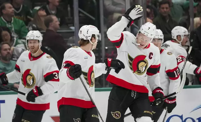 Ottawa Senators center Ridly Greig, center left, is congratulated by left wing Brady Tkachuk, center right, after scoring a goal against the Dallas Stars during the first period of an NHL hokey game, Thursday, Jan. 2, 2025, in Dallas. (AP Photo/Julio Cortez)