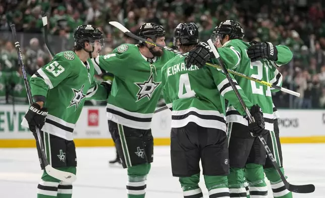 Dallas Stars players celebrate a goal by center Roope Hintz, second from left, during the first period of an NHL hokey game against the Ottawa Senators, Thursday, Jan. 2, 2025, in Dallas. (AP Photo/Julio Cortez)