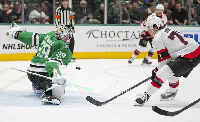 Dallas Stars goaltender Jake Oettinger (29) blocks a shot as Ottawa Senators center Ridly Greig attacks during the second period of an NHL hokey game, Thursday, Jan. 2, 2025, in Dallas. (AP Photo/Julio Cortez)