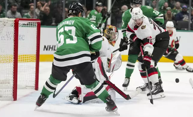 Dallas Stars center Wyatt Johnston (53) attacks against Ottawa Senators goaltender Leevi Merilainen, center, and defenseman Thomas Chabot (72) during the first period of an NHL hokey game, Thursday, Jan. 2, 2025, in Dallas. (AP Photo/Julio Cortez)