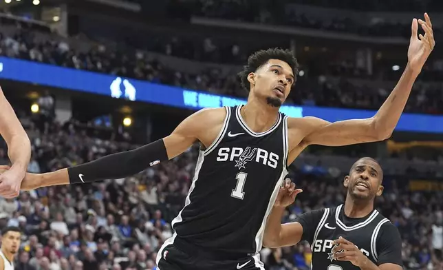 San Antonio Spurs center Victor Wembanyama pursues a rebound in the first half of an NBA basketball game against the Denver Nuggets Friday, Jan. 3, 2025, in Denver. (AP Photo/David Zalubowski)