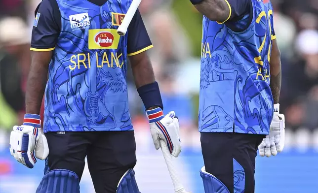 Sri Lanka's Avishka Fernando, right, celebrates after scoring 50 runs during the first ODI international cricket match between New Zealand and Sri Lanka at the Basin Reserve in Wellington, New Zealand, Sunday, Jan. 5, 2025. (Kerry Marshall/Photosport via AP)