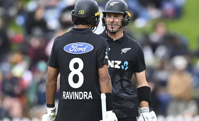 New Zealand's Rachin Ravindra and Will Young interact during the first ODI international cricket match between New Zealand and Sri Lanka at the Basin Reserve in Wellington, New Zealand Sunday, Jan. 5, 2025. (Kerry Marshall/Photosport via AP)