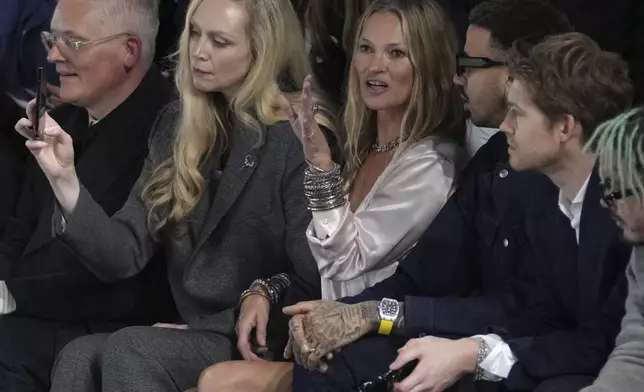 Gwendoline Christie, second left, Kate Moss, center, Miles Chamley-Watson and Joe Alwyn, right, attend the men's Dior Homme Fall-Winter 2025-2026 collection, that was presented in Paris, Friday, Jan. 24, 2025. (AP Photo/Thibault Camus)