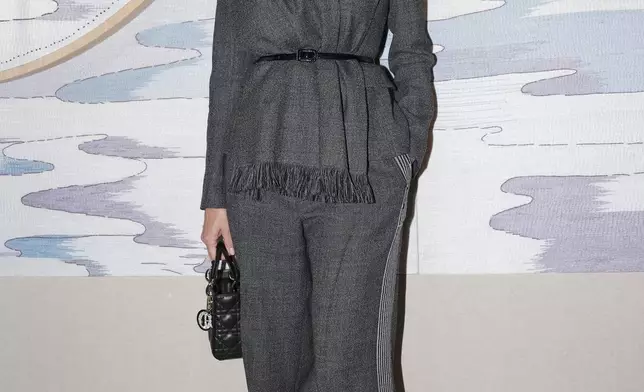 Pamela Anderson arrives for the Christian Dior Haute Couture Spring Summer 2025 collection, that was presented in Paris, Monday, Jan. 27, 2025. (AP Photo/Lewis Joly).