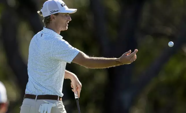 Will Zalatoris tosses his ball to his caddie on the fourth green during the first round of The Sentry golf event, Thursday, Jan. 2, 2025, at Kapalua Plantation Course in Kapalua, Hawaii. (AP Photo/Matt York)