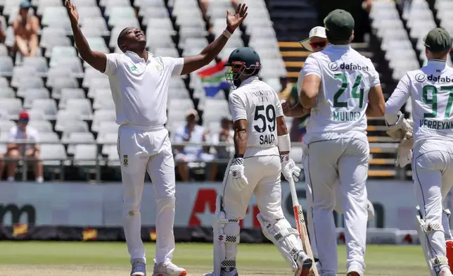 South Africa's Kagiso Rabada, left, celebrates the wicket of Pakistan's Saud Shakeel during the fourth day of the second test match between South Africa and Pakistan in Cape Town, South Africa, Monday, Jan. 6, 2025. (AP Photo/Halden Krog)