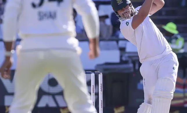 South Africa's David Bedingham smashes the ball towards Pakistan's Shan Masood (c) during the fourth day of the second test match between South Africa and Pakistan in Cape Town, South Africa, Monday, Jan. 6, 2025. (AP Photo/Halden Krog)