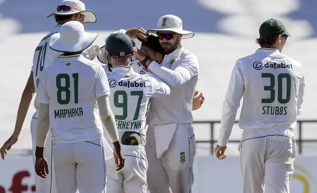 South Africa players celebrate the wicket of Pakistan's Salman Agha during the fourth day of the second test match between South Africa and Pakistan in Cape Town, South Africa, Monday, Jan. 6, 2025. (AP Photo/Halden Krog)