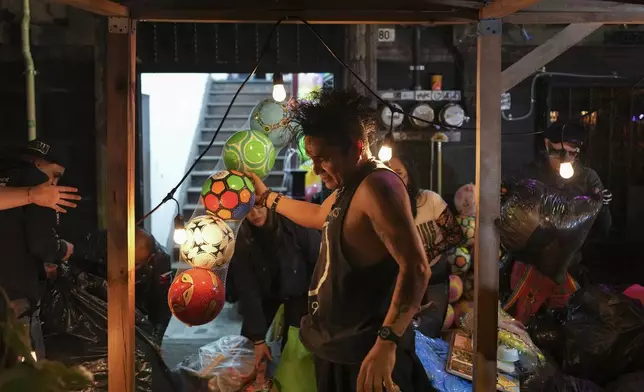 Volunteers known as the Punk Kings load a truck to distribute toys, clothes and pinatas to disadvantaged children in celebration of Epiphany, or Three Kings Day, in Mexico City, Sunday, Jan. 5, 2025. (AP Photo/Eduardo Verdugo)