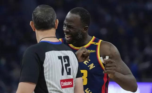 Golden State Warriors forward Draymond Green, right, speaks with referee J.T. Orr during the first half of an NBA basketball game against the Miami Heat, Tuesday, Jan. 7, 2025, in San Francisco. (AP Photo/Godofredo A. Vásquez)